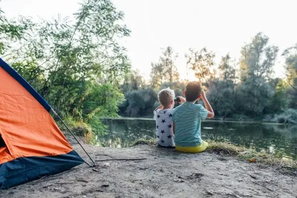 kids camping on lakeside